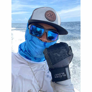 Person wearing Glacier Glove fishing gloves and blue neck gaiter on a boat