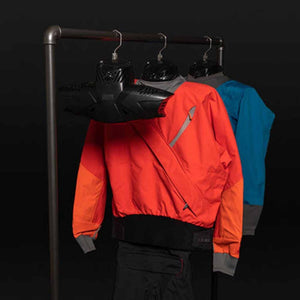 Orange and blue dry tops hanging on a rack with black drying hangers