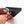 Hand using a power drill to mount a black GearDryer wall bracket