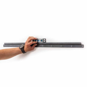 Hand using a spirit level to align a GearDryer wall mounting bracket