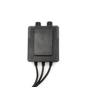 Black rectangular electronic control module with two top knobs and three bottom cables