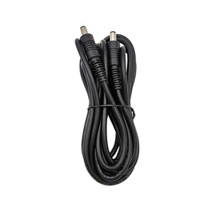 Black DC power cable with two barrel connectors coiled on white background