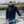 Man wearing a black Gerbing softshell jacket standing by a railing