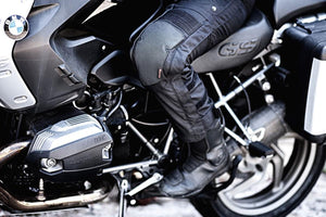 Person wearing Gerbing black motorcycle pants with knee protection sitting on a BMW motorcycle