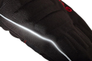 Close up of black quilted fabric with a reflective silver piping detail