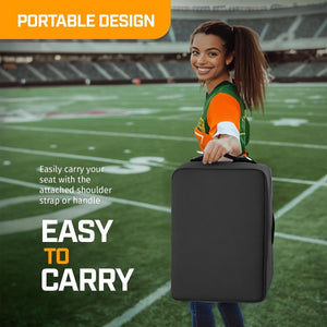 Person carrying a black portable stadium seat with a handle on a football field