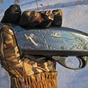 Glacier Glove camouflage hunting glove holding a Remington shotgun