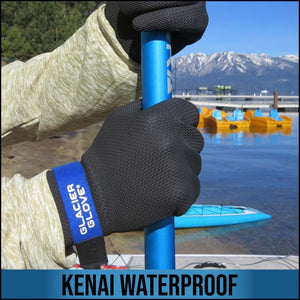 Person wearing black Glacier Glove Kenai waterproof gloves holding a blue paddle by a lake