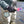 Person wearing Glacier Glove brand gloves while holding a fly fishing rod in a river