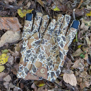 Glacier Glove camouflage pattern outdoor glove on a bed of fallen leaves