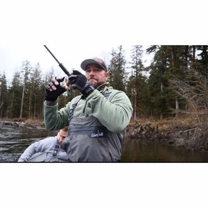Man wearing Glacier Glove fingerless gloves while fishing in a river