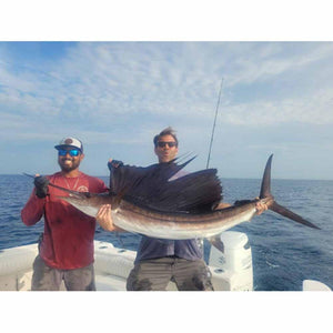 Two men holding a large sailfish on a boat wearing Glacier Glove fishing gear