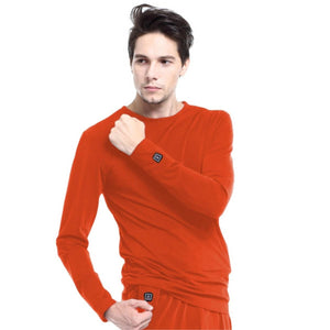 Man wearing orange Glovii long sleeve heated base layer shirt