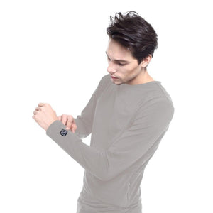 Man wearing a grey Glovii long sleeve heated shirt with a power button on the cuff