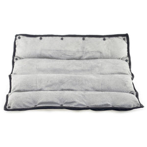Grey plush rectangular heating pad with black trim and snap buttons