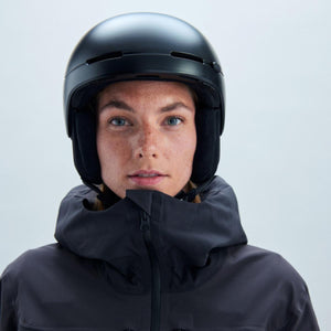 Person wearing a black POC ski helmet and black jacket
