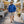 Man wearing a blue Gobi Heat jacket with a straw hat and sunglasses walking through an outdoor market