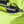 Black power bank connected to a USB cable inside a lime green backpack pocket