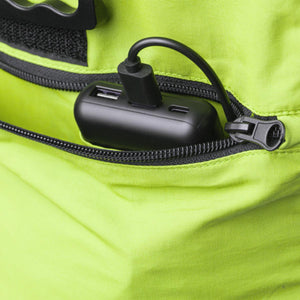 Black power bank connected to a USB cable inside a lime green backpack pocket