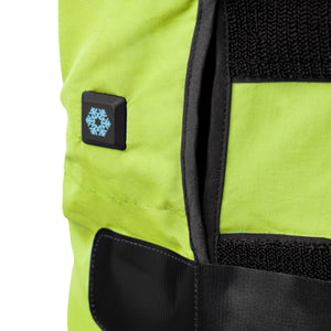 Close up of a neon yellow heated garment with a snowflake icon power button