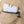 White plastic ice pack with fill water to this line text inside a tan fabric pocket