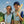 Two children wearing Gobi Heat cooling vests with blue tubing patterns on a sports field