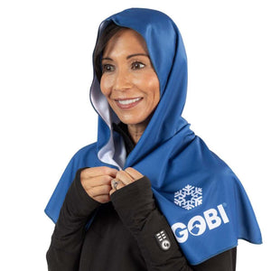 Woman wearing a blue Gobi Heat cooling hood over a black shirt