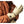 Person wearing Gobi Heat tan leather heated gloves with power button on wrist