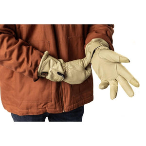 Person wearing beige leather work gloves with a power button on the wrist