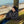 Man wearing Gobi Heat jacket and beanie resting in a hammock by a tree