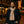 Man wearing a Gobi Heat beige scarf and dark coat on a city street at night