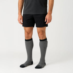 Person wearing Gobi Heat grey knee high socks with battery pocket