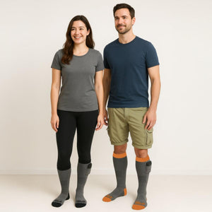 Man and woman wearing Gobi Heat grey heated socks with battery packs