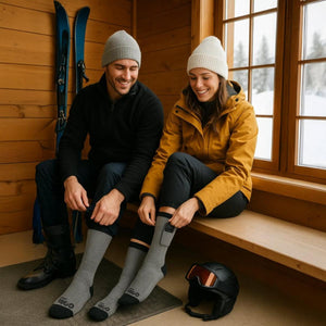 Couple wearing Gobi Heat heated socks in a wooden cabin