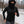 Person wearing a black Gobi Heat hooded quarter zip running in a snowy park