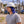 Worker wearing a Gobi Heat blue neck shade under a white hard hat at an industrial site