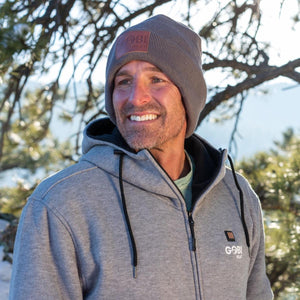 Man wearing a grey Gobi Heat beanie and a grey zip up hoodie outdoors