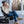 Woman sitting in a Gobi Heat camping chair on a deck drinking from a white mug