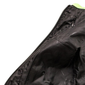 Close up of black jacket lining with zipper and neon green collar detail