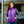 Woman wearing a purple Gobi Heat quilted vest over a plaid shirt