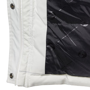 Close up of white jacket zipper and black interior lining with geometric pattern