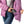 Person placing a Gobi Heat power bank into the interior pocket of a purple puffer jacket