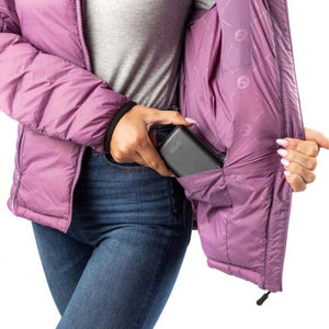 Person placing a Gobi Heat power bank into the interior pocket of a purple puffer jacket