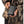 Person wearing camouflage jacket holding black Gobi Heat power bank