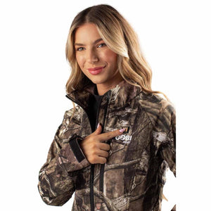 Woman wearing Gobi Heat camouflage jacket pointing to the logo