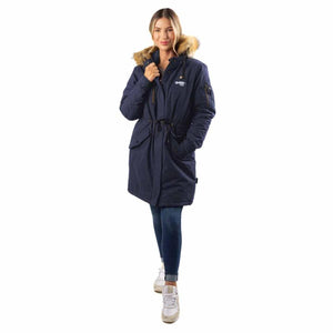 Woman wearing a navy blue Gobi Heat parka with a faux fur hood