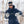 Person wearing Gordini gloves assembling a folding ski pole in a snowy forest