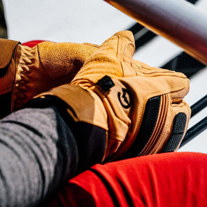 Gordini tan leather gloves with black accents worn on hands