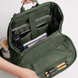 Open Got Bag backpack showing internal compartments with laptop, notebook, pens, and water bottle