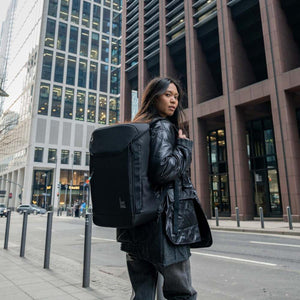 Person wearing a black Got Bag backpack on a city street